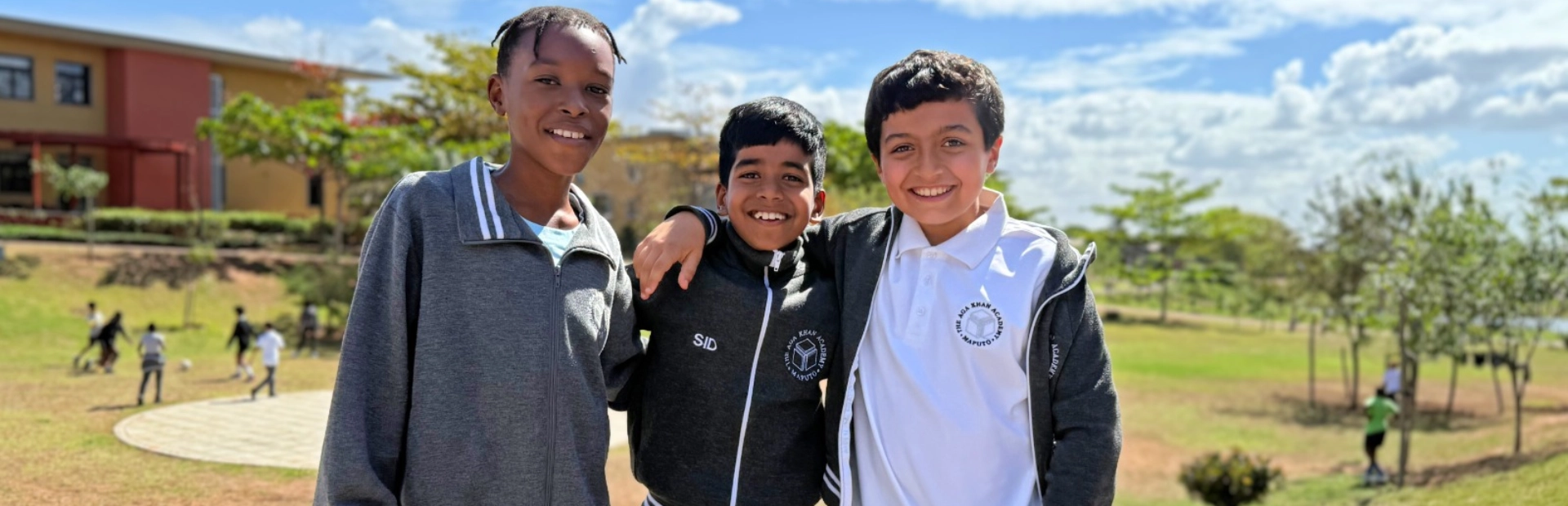 Student sitting with a tablet in front of her. The student is looking down at the tablet.
